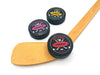 three hockey pucks with wooden hockey stick with red, pink, and yellow hockey team designs on white background