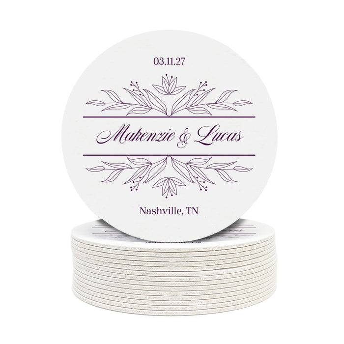 A stack of custom round coasters against a white background. Coasters feature a personalized floral design with the happy couple's first names, wedding date, and location.