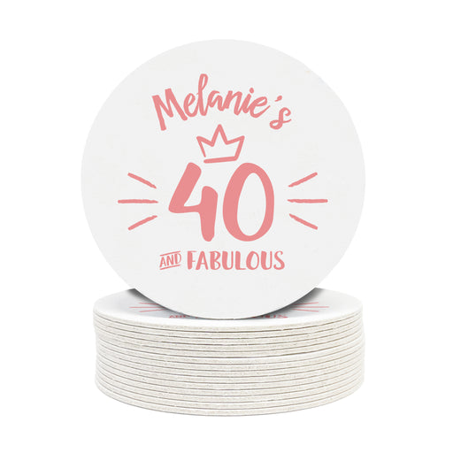 A stack of white round coasters with the words Melanie's 40 and Fabulous in pink printed on them.