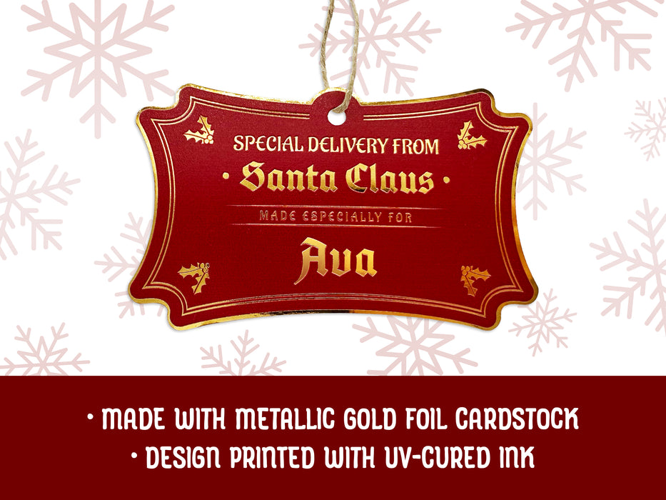 A gold foil cardstock hanging Santa gift tag is shown on a white background with red snowflakes. Text underneath the tag reads: Made with metallic gold foil cardstock, Design printed with UV-cured ink.