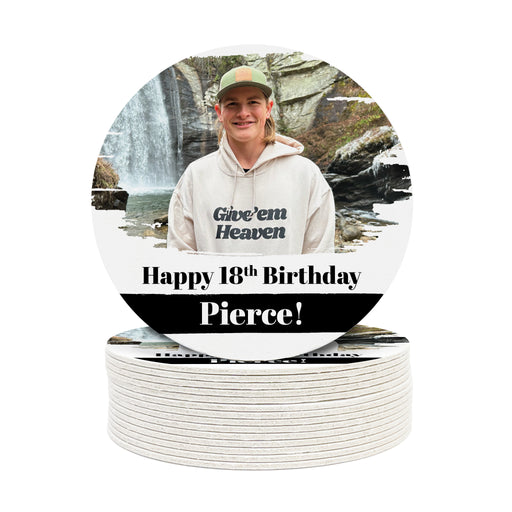A single coaster is shown on top of a stack of other coasters. Coasters shown are customizable. Coasters are designed with custom photo, text, and brushed elements. Coaster text reads Happy 18th Birthday Pierce!