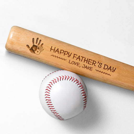 Photo of laser engraved Fathers Day Handprint mini bat design next to a baseball