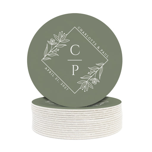 A stack of custom round coasters against a white background. Coasters feature a floral diamond design with a monogram, wedding couple's names, and wedding date.