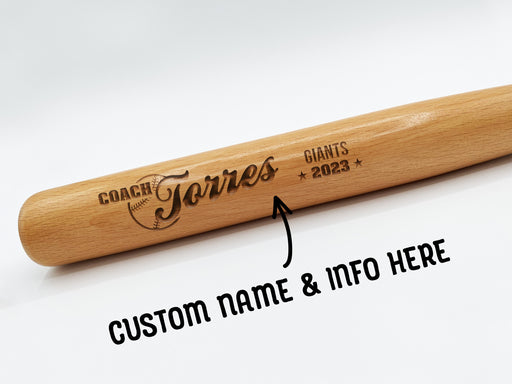 wooden mini baseball bat with custom laser engraved design that features a coach name design with team and year says "Coach Torres, Giants 2023" on a white surface with arrow and text that says custom name & info here