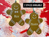 Ornaments shown hanging from Christmas tree. These ornaments are wooden and shaped like a gingerbread boy and girl. Names and years are written on ornaments in white. The text "2 Styles Available" is shown above ornaments.