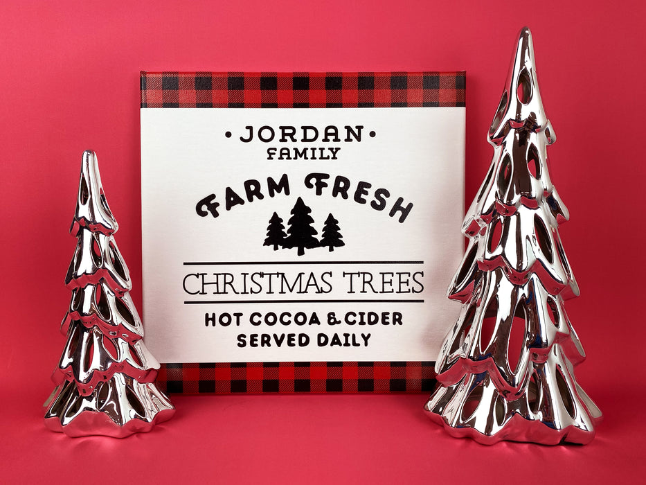 Farm Fresh Christmas Trees design shown on canvas. Design has red and black plaid border with the black text, Jordan Family Farm Fresh Christmas Trees Hot Cocoa & Cider Served Daily.