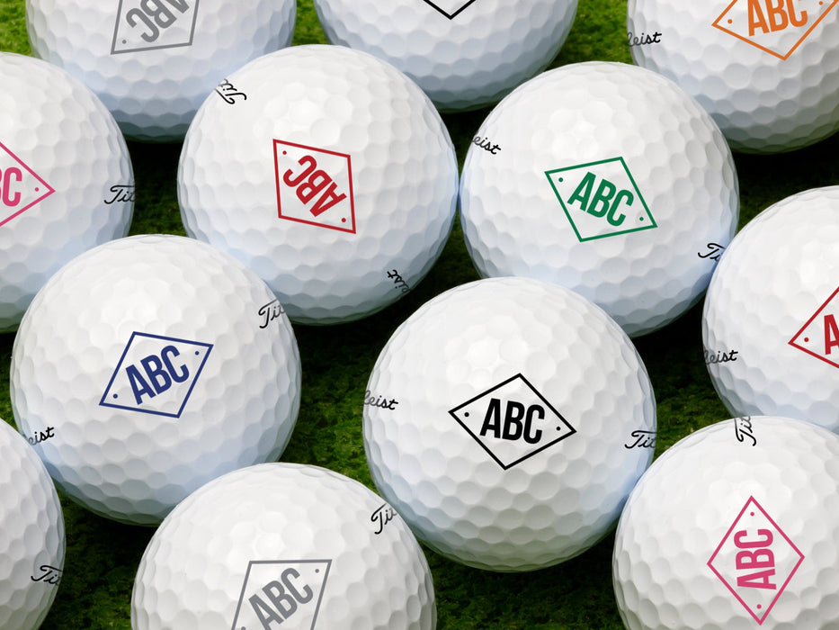 Multiple golf balls shown with diamond monogram design in all available colors.