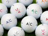 Multiple golf balls shown with line monogram design in all available colors.