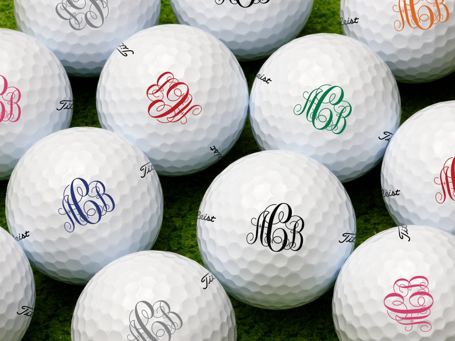 Multiple golf balls shown with scroll monogram design in all available colors.