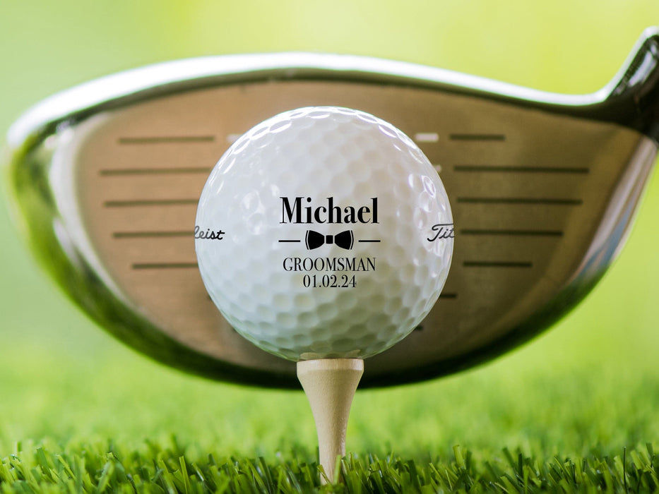 Golf ball on tee shown with Wedding Bowtie design. A golf club can be seen behind the ball.
