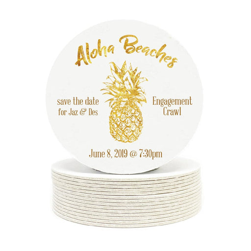 Single coaster is shown on top of a stack of coasters. Coasters are white and feature Aloha Beaches design. Design is printed with a gold texture and shows the words Aloha Beaches and has a pineapple on it. The words "save the date for Jaz & Des, Engagement Crawl, June 8, 2019 @ 7:30pm" can also been seen on the coaster.