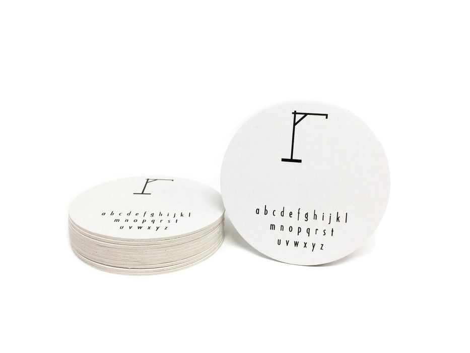 Single coaster is shown sitting next to a stack of coasters on a white background. Coasters feature Hangman Game design. This design has a hangman game printed in black on white coasters.