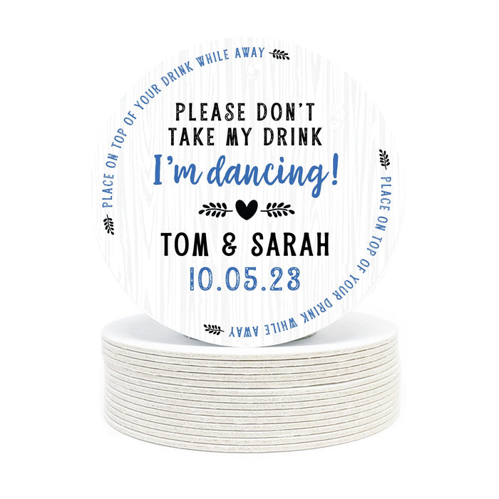 Single coaster is shown on top of a stack of coasters. Coasters say Please Don't Take My Drink I'm Dancing with wedding couple names and wedding date. The words, place on top of your drink while away, act as a border around coaster.