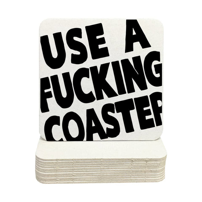 Single coaster is shown on top of a stack of coasters on a white background. Coasters feature Use A Fucking Coaster design.