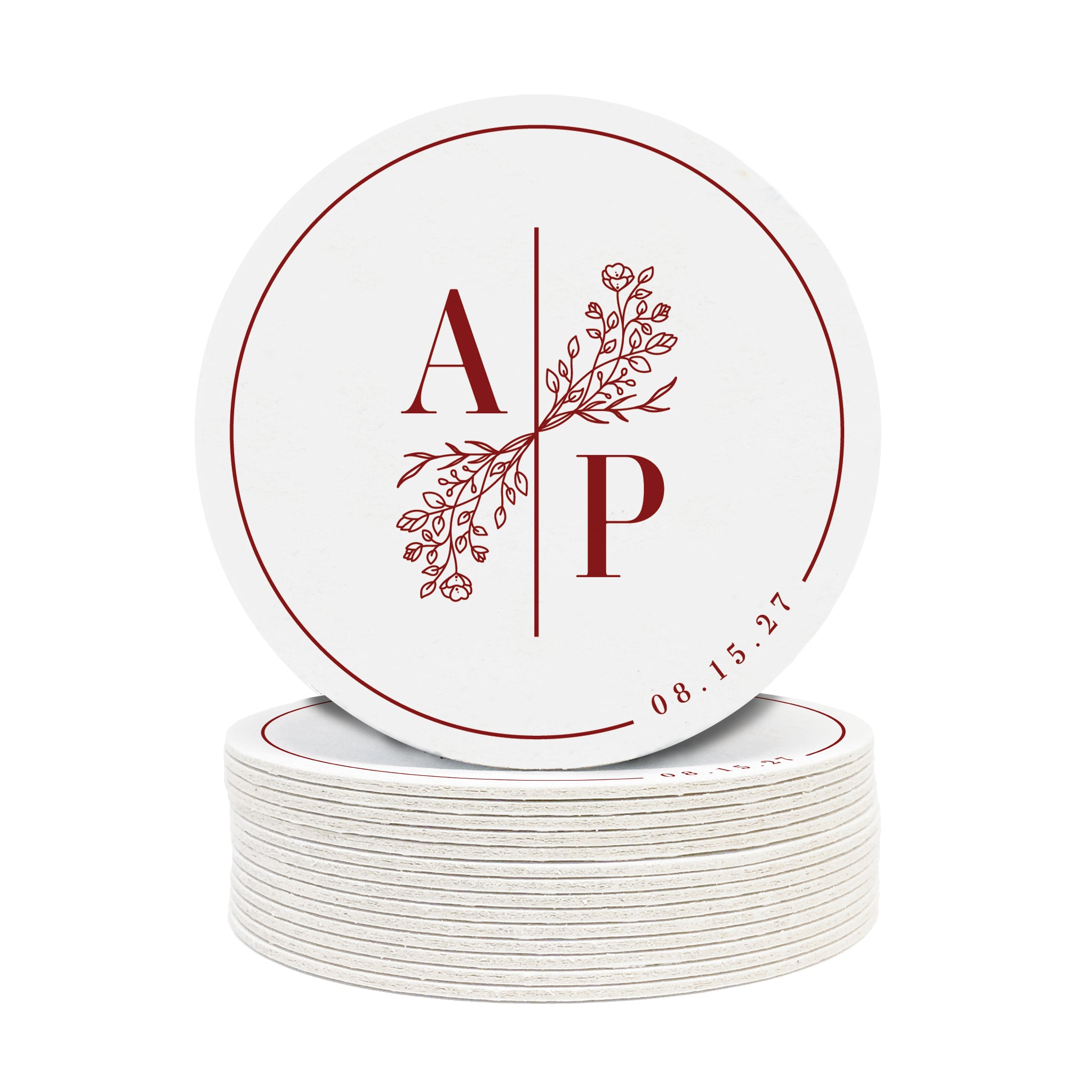 A stack of custom round coasters against a white background. Coasters feature a custom floral monogram design with two initials and floral decoration in the middle and a border with a wedding date on the side.