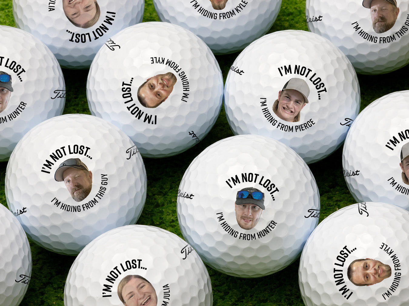 Single white Titleist golf ball with I'm Not Lost, I'm Hiding From design on white golf tee with golf course grass in the background.