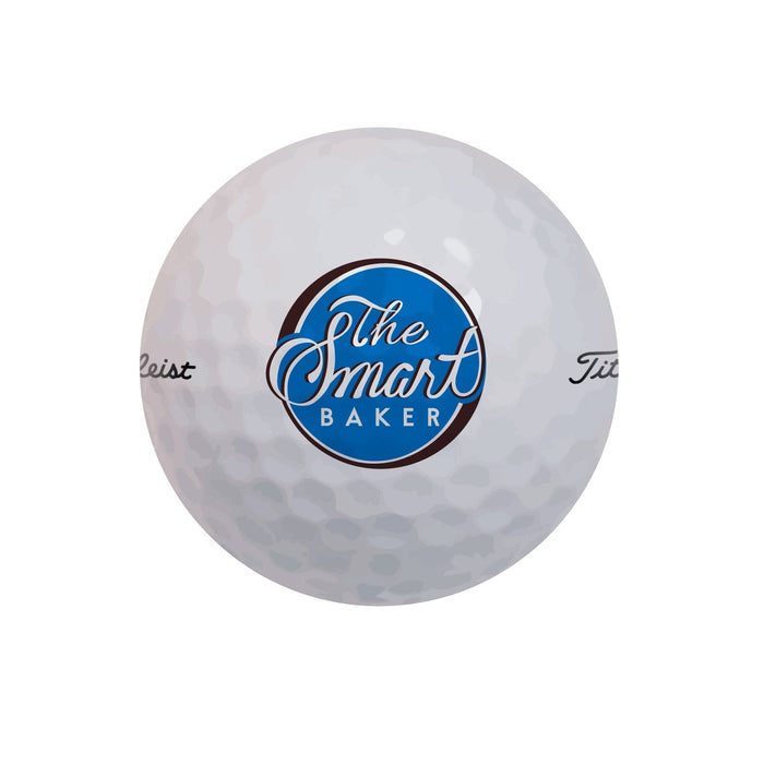 Golf ball is shown with The Smart Baker logo. Golf ball is set on white background.
