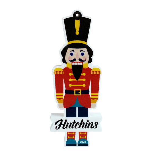 Ornament shown features Nutcracker Design. The ornament made from PVC and shaped like a nutcracker. A last name and year are written on the ornament.