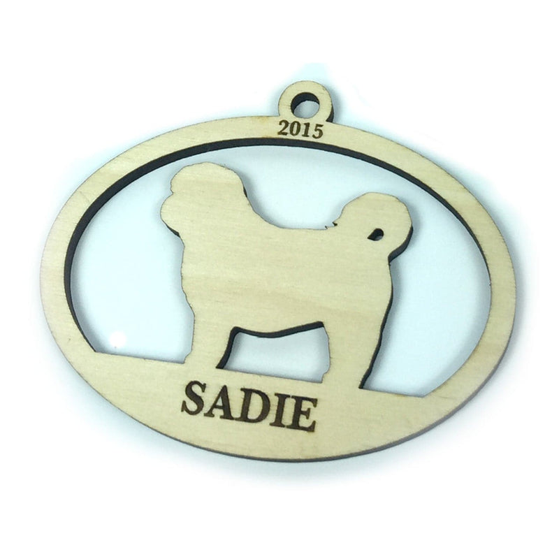 Ornament on white background. Ornament design has a dog silhouette with the year and pet's name engraved on wooden ornament.