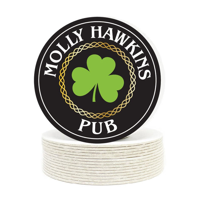 Single coaster is shown on top of a stack of coasters on a white background. Coasters feature Irish Pub design. Design shows the text “Molly Hawkins Pub” in a white serif type and an ornamental, gold circle with a green, 3-leaf shamrock in the middle. Design is printed with a black background on a round coaster.
