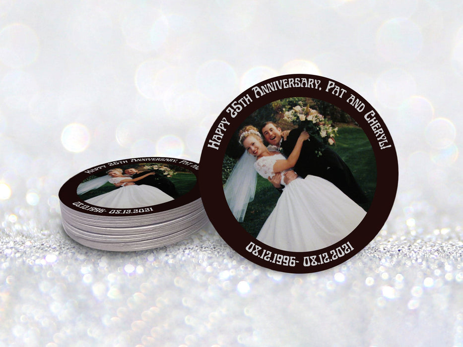 A stack of coasters by a single coaster in front of a glittery background. Coasters display a custom design for a wedding anniversary with text and a photo.