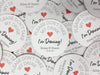 Multiple coasters spread in all different directions. Coasters say please don't take my drink I'm dancing with married couple names and wedding date below. Red heart featured in the middle of coaster.