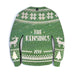 Ornament features an Ugly Sweater design. Design is green and made in a sweater shape with white stitched decorative details. Decorative reindeer and Christmas trees are on sleeves. Custom last name and year are printed in white in the center.