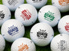 Multiple white titleist golf balls with Kick Putt Dad design in all available color options on golf course grass