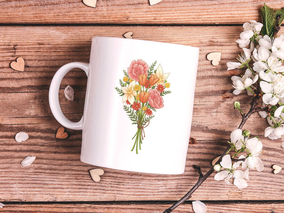 15 ounce ceramic mug featuring artwork of a bouquet of pastel spring flowers on a wooden table next to a bunch of white flowers surrounded by rose petals