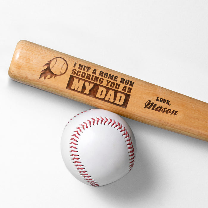 Photo of laser engraved Fathers Day Home Run mini bat design next to a baseball