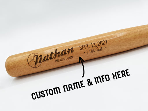 wooden mini baseball bat with custom laser engraved design that features a baby name design with a date and info text and says "Nathan, Future All-Star, Sept. 13, 2021, 7 LBS. 3oz" on a white surface with arrow and text that says "custom name & info here"