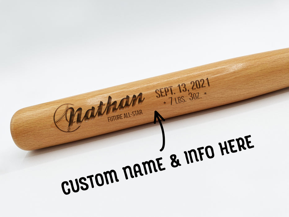 wooden mini baseball bat with custom laser engraved design that features a baby name design with a date and info text and says "Nathan, Future All-Star, Sept. 13, 2021, 7 LBS. 3oz" on a white surface with arrow and text that says "custom name & info here"