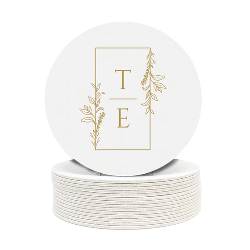 A stack of custom round coasters against a white background. Coaster has Floral Framed Mongram design on it with the initials TE.