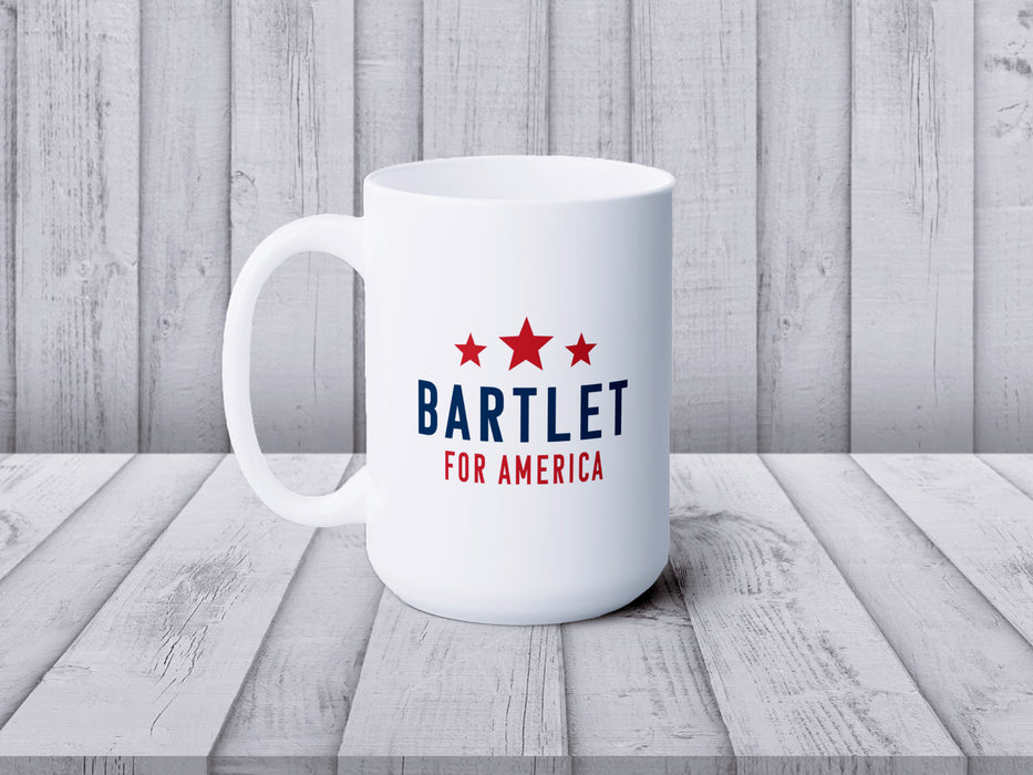 white mug with red white and blue American design with typography that says Bartlet for America with Red Stars on wooden table with a wooden wall