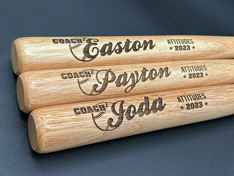 Personalized Mini 18 Inch Wood Baseball Bats shown. Single bat is shown with a custom design. Design features coach names, a baseball illustration, team name, and year.