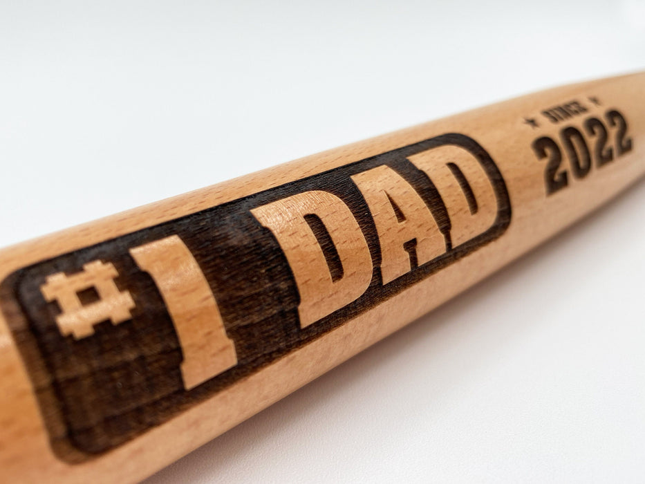Close-up look of laser engraved #1 Dad mini bat design.