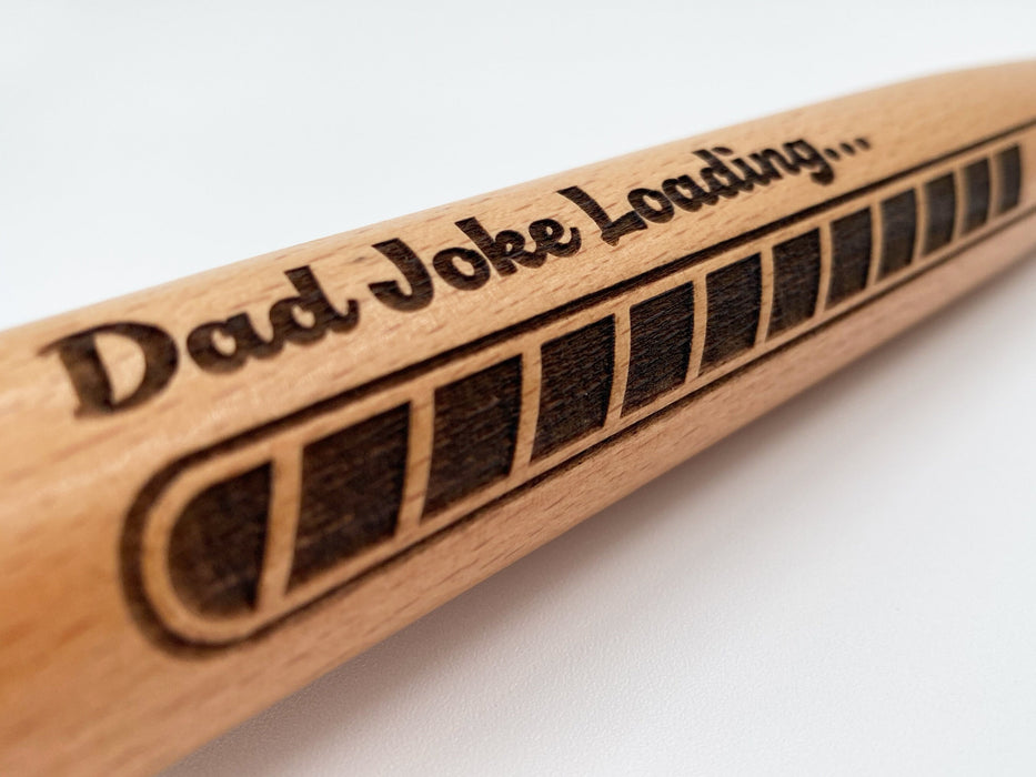 Close-up look of laser engraved Dad Joke Loading mini bat design.