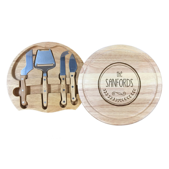 wooden cheeseboard with stainless steel cheese knives toolset with last name and initial engraving of The Sanford with a circle and wreath design