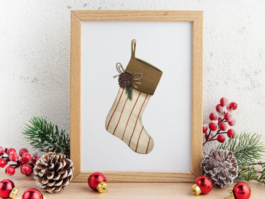 wooden frame with christmas print of a rustic stocking ontop of wooden countertop surrounded by winter decor such as pinecones, pine leaves, holly berries, and red ornaments