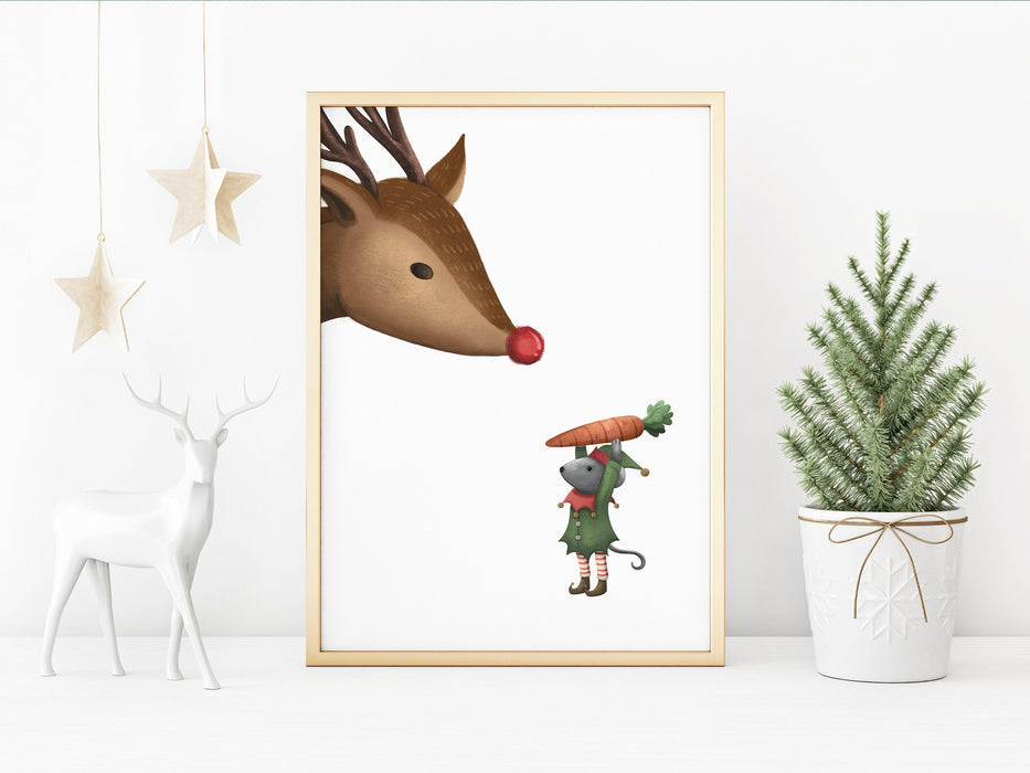 gold framed Christmas print with an elf mouse holding a carrot to a reindeer surrounded by holiday decor such as a gold hanging stars, a white deer statue, and a mini pine tree in a white plant pot