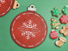 red ornament holiday cookie tray that says Mason and Malia with snowflake design on green background surrounded by holiday cookies