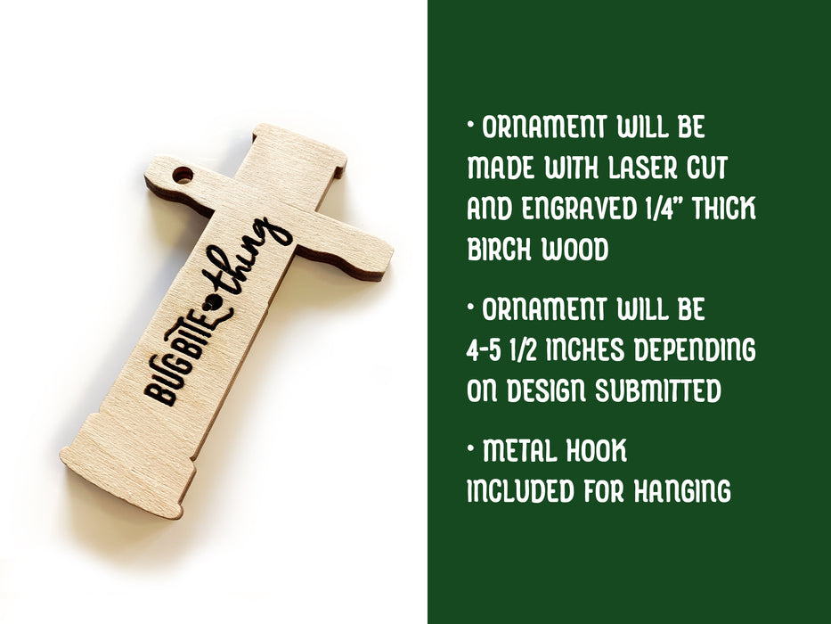 Text: Ornament will be made with laser cut and engraved 1/4 inch thick birch wood, ornament will be 4-5 1/2 inches depending on design submitted, metal hook included for hanging. Image: Custom ornament for the BugBite Thing is shown.