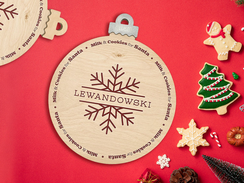 wooden ornament Christmas cookie tray with a snowflake design that says Lewandowski and Milk and Cookies for Santa on a red background surrounded by various holiday cookies