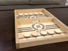 puck sling board game with an S monogram with wreath design that reads The Scott Family on a dark wood living room coffee table