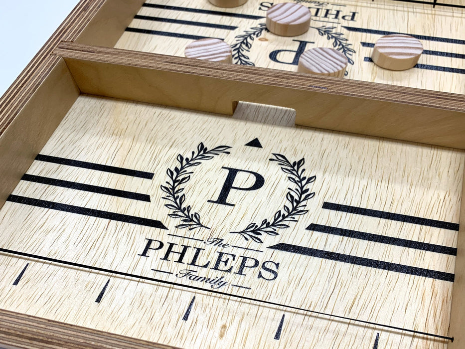 puck sling board game with an P monogram with wreath design that reads The Phleps Family