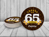 A stack of coasters by a single coaster on a white wooden background. Text above coasters say your custom text here! Coasters say Cheers to 65 Years, Calvin!