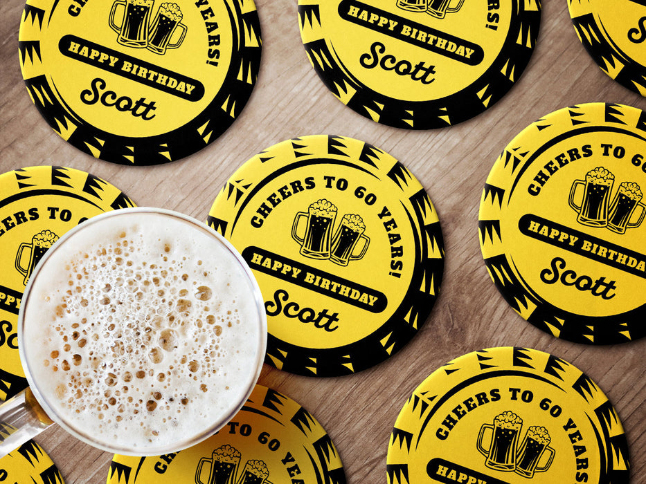 Multiple coasters shown on a wooden surface with a beer mug. Coasters say Cheers to 60 Years! Happy Birthday Scott.