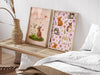 two easter prints with pastel easter artwork in wooden frames on a wooden bench next to a bed surrounded by a bedroom rug and pillows