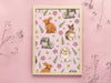 wooden frame with print of pastel bunny and flower pattern in front of light pink background
