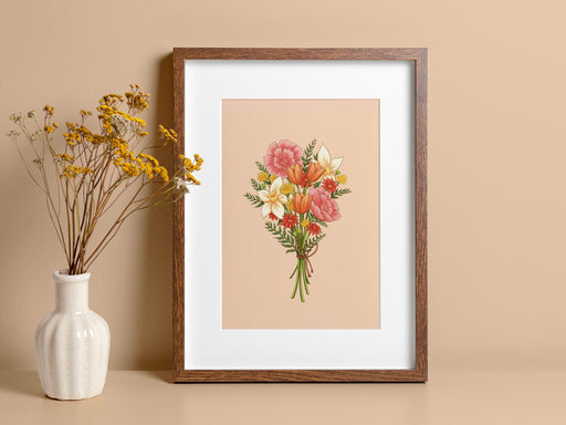 wooden frame with a pastel easter print featuring a spring bouquet of colorful flowers on a tan counter next to a white vase with yellow flowers